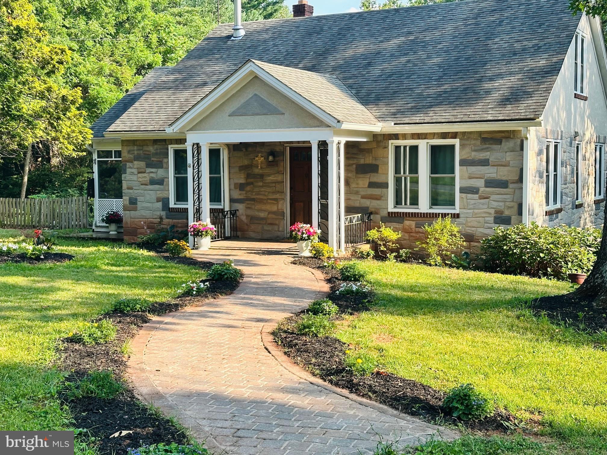 a front view of a house with garden and porch
