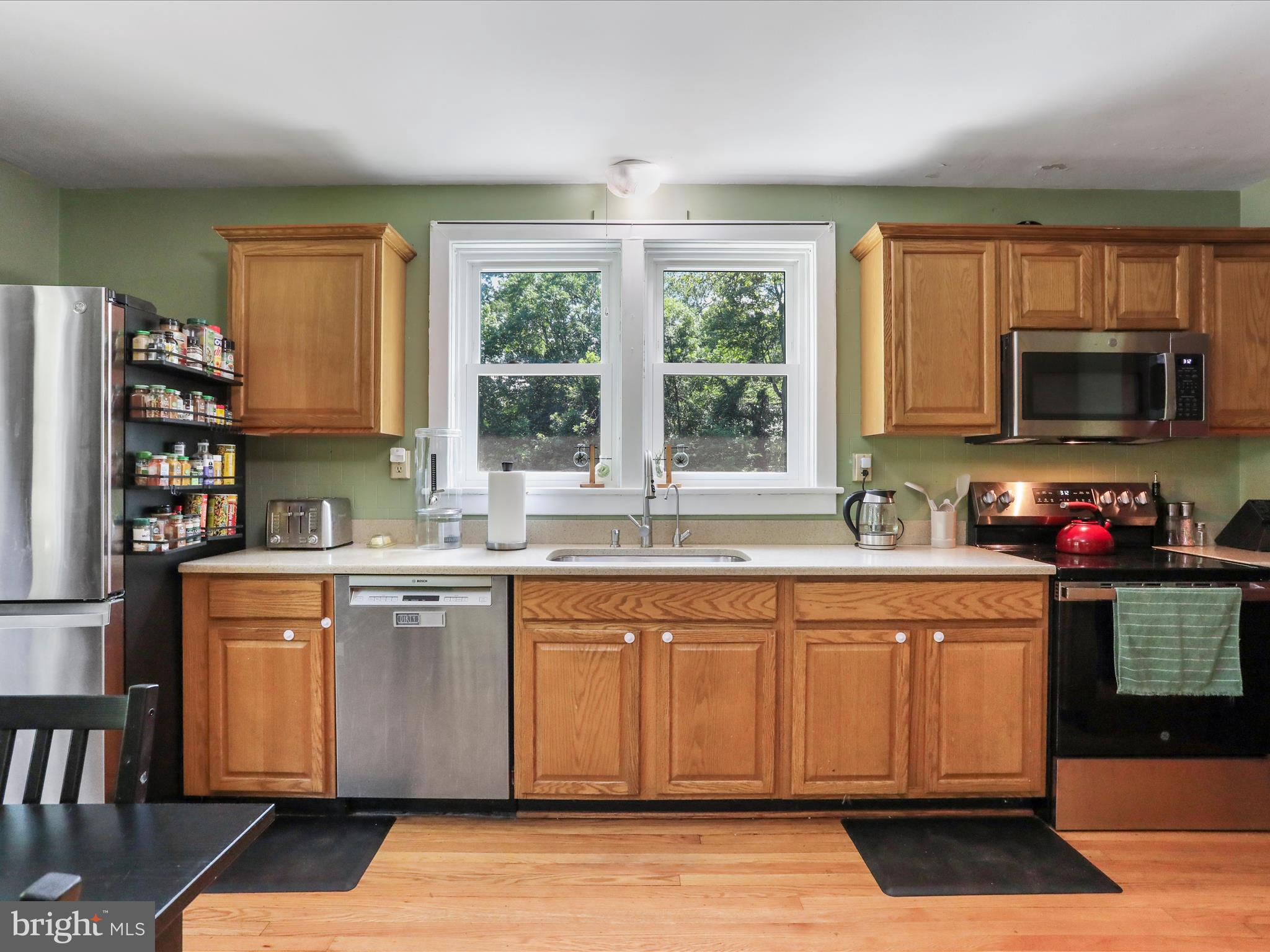 6927 Kellys Store Road Thurmont, MD 21788 - Photo 6 of 42 a kitchen with stainless steel appliances granite countertop a stove a sink and a microwave