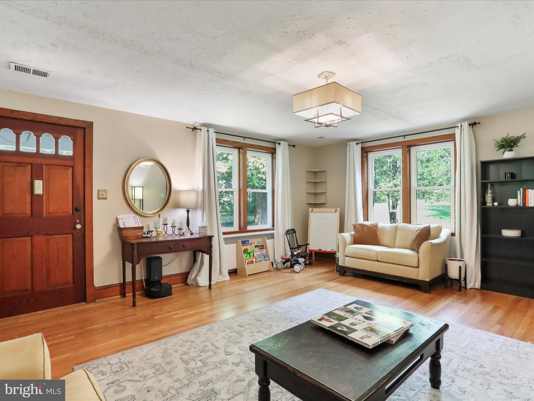 6927 Kellys Store Road Thurmont, MD 21788 - Photo 10 of 42 a living room with furniture a table and a large window