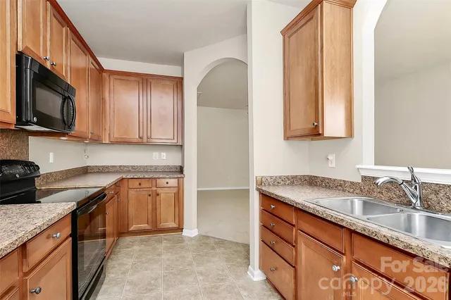 a kitchen with stainless steel appliances granite countertop a sink stove and microwave