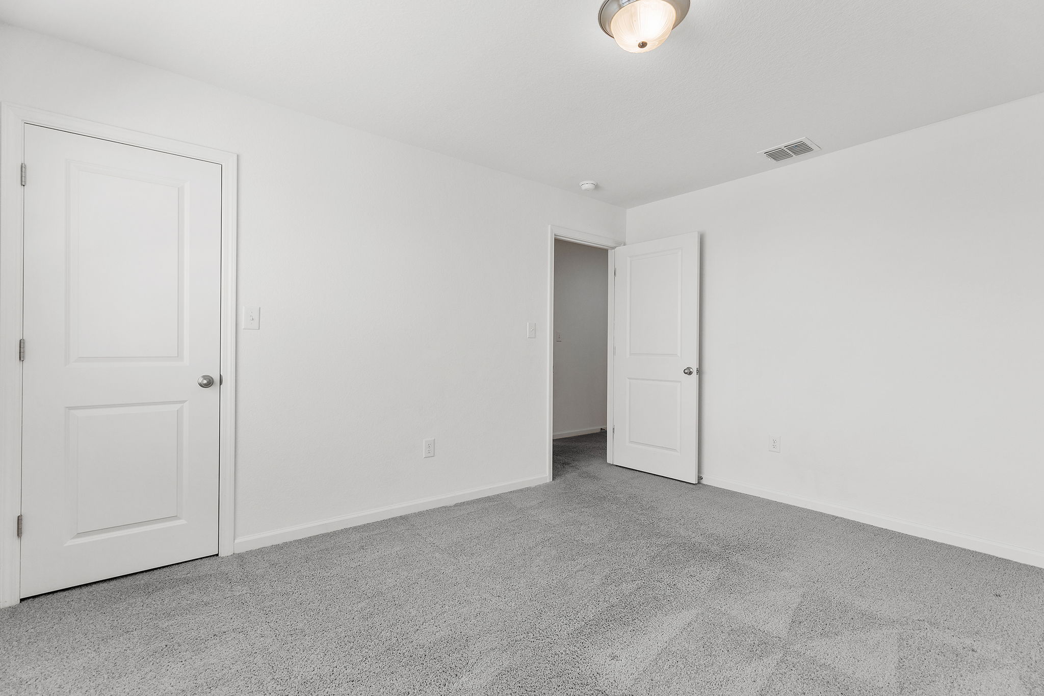 409 Line Of Fire Way Jarrell, TX 76537 - Photo 27 of 30 Spacious room featuring light gray carpeting, white walls, baseboard trim, and open wall space for flexible furniture placement.