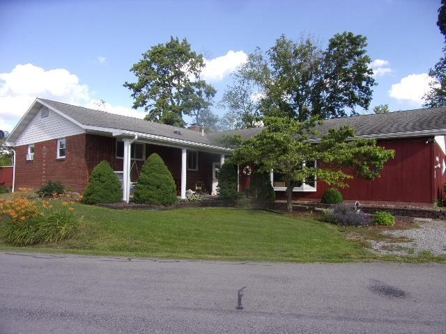 28 Graff Road Knox, PA 16232 - Photo 1 of 17 a front view of a house with a garden and trees