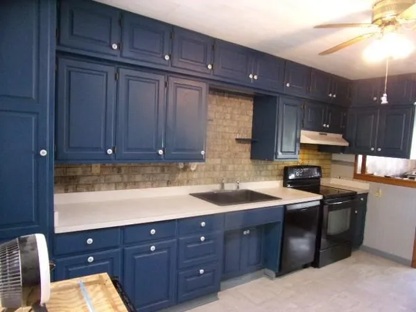 a kitchen with a sink and cabinets