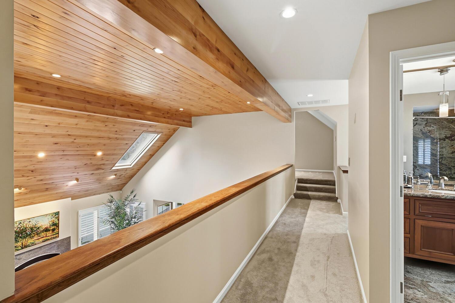 1749 Haggin Grove Way Carmichael, CA 95608 - Photo 40 of 99 a view of a hallway with wooden floor and staircase