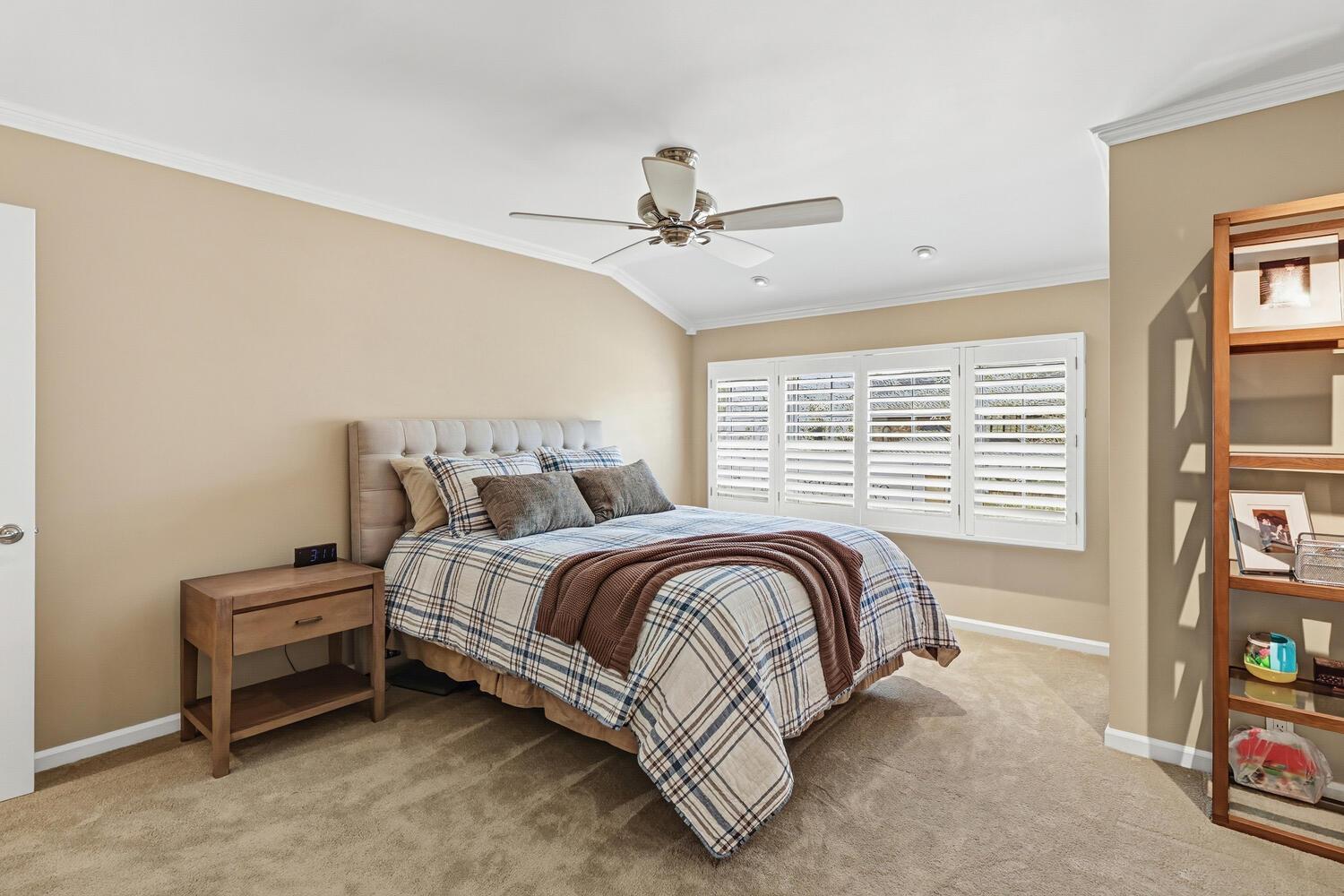 1749 Haggin Grove Way Carmichael, CA 95608 - Photo 48 of 99 a spacious bedroom with a bed a dresser and a chandelier