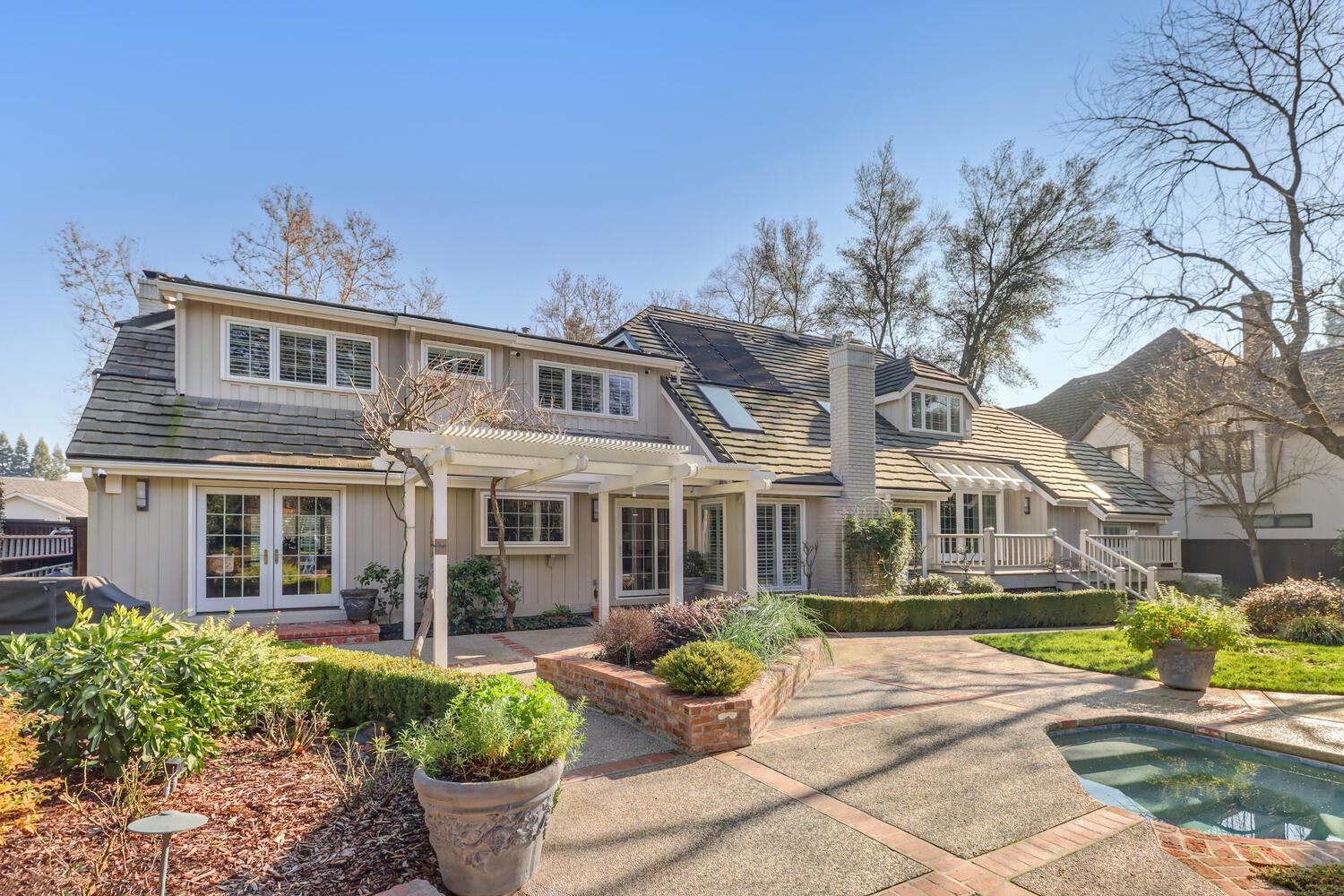1749 Haggin Grove Way Carmichael, CA 95608 - Photo 76 of 99 a front view of a house with a garden and potted plants