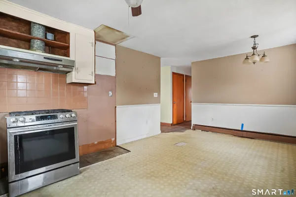 a view of a kitchen with cabinets and stainless steel appliances
