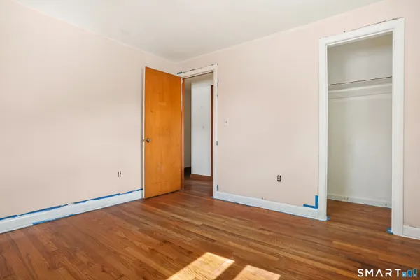 a view of an empty room with wooden floor
