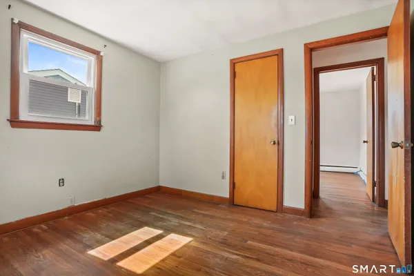 a view of an empty room and wooden floor
