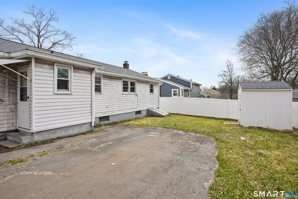 a view of a house with a backyard