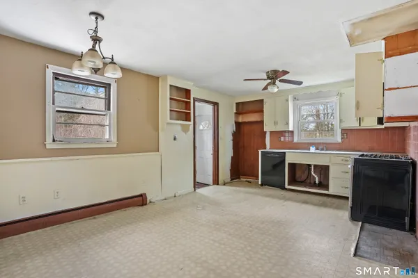 a living room with stainless steel appliances granite countertop furniture and a fireplace