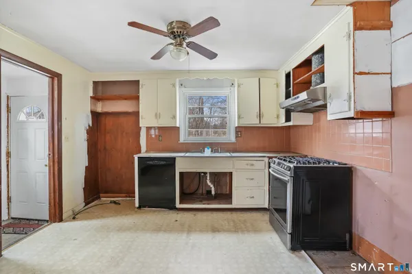a kitchen with stainless steel appliances granite countertop a stove sink and cabinets