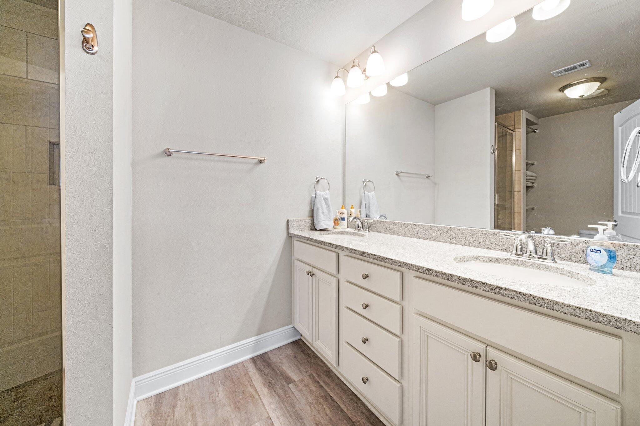 64 Crossing Lane, Unit E Santa Rosa Beach, FL 32459 - Photo 12 of 22 a bathroom with a double vanity sink and a mirror