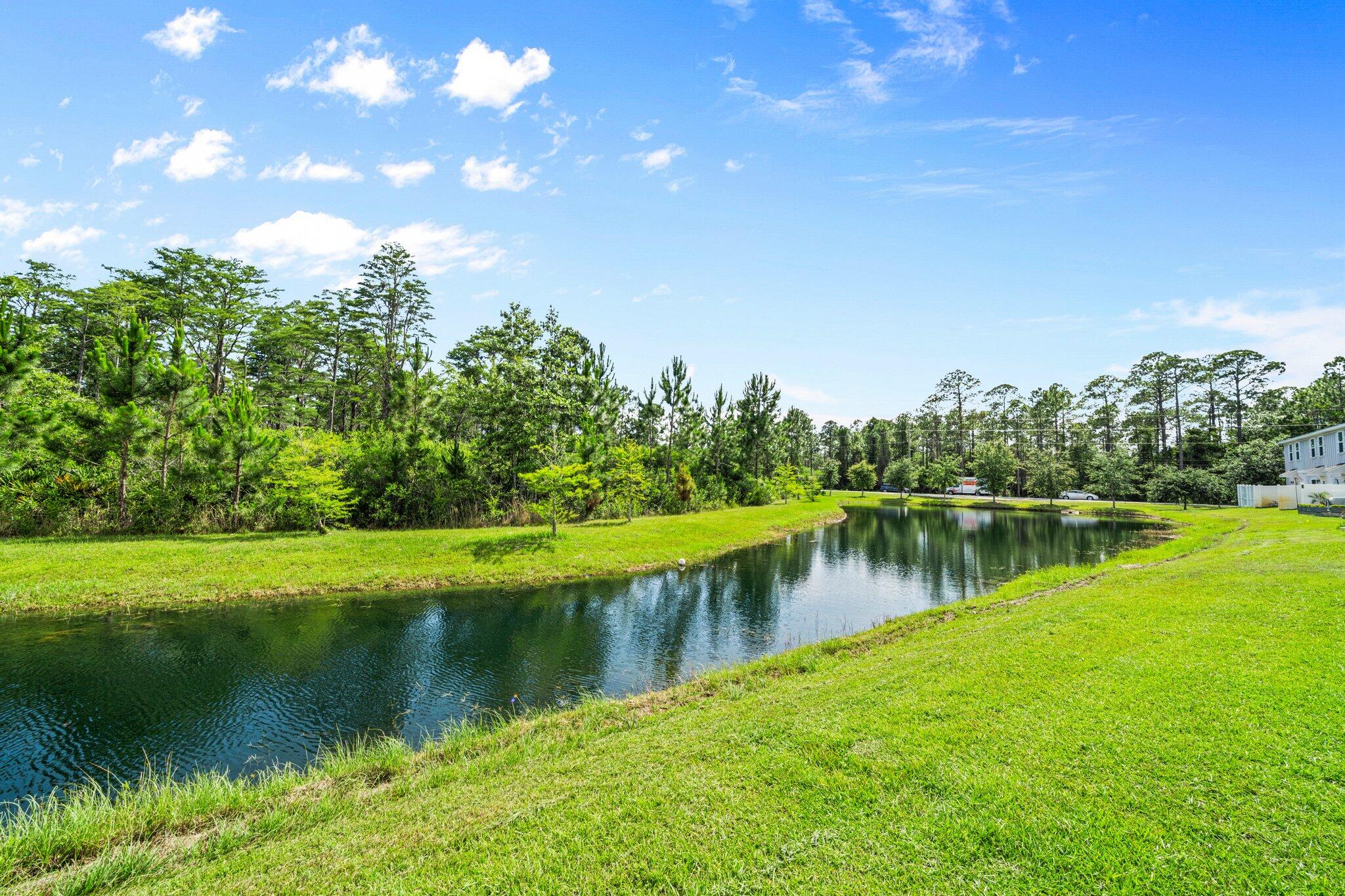 64 Crossing Lane, Unit E Santa Rosa Beach, FL 32459 - Photo 20 of 22 a view of a lake with a yard
