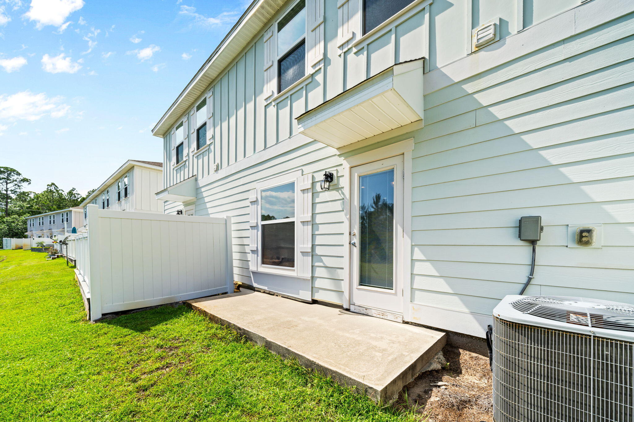64 Crossing Lane, Unit E Santa Rosa Beach, FL 32459 - Photo 21 of 22 front view of a house with a yard