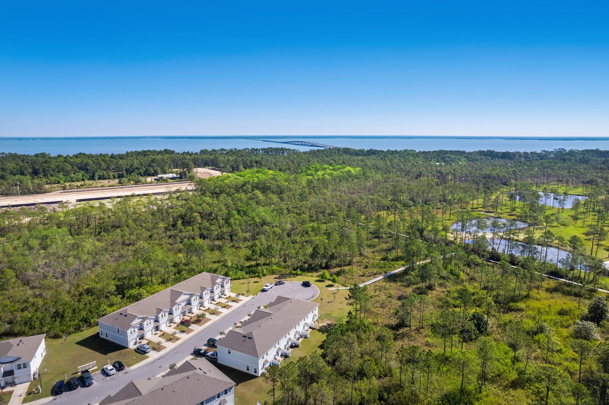 64 Crossing Lane, Unit E Santa Rosa Beach, FL 32459 - Photo 22 of 22 a view of a city with lush green forest