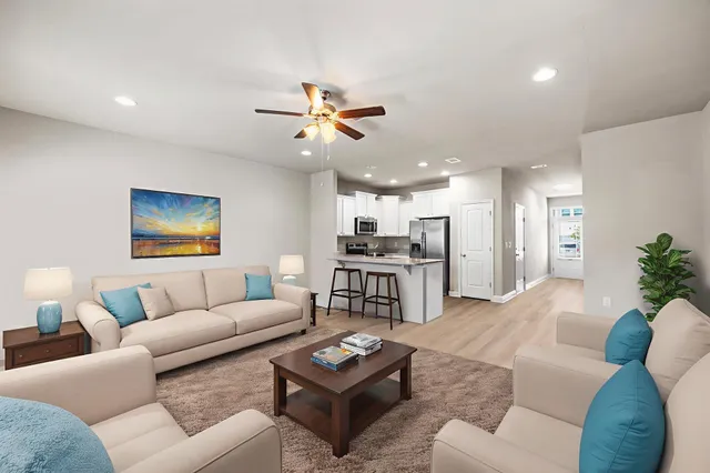 a living room with furniture a rug and a chandelier