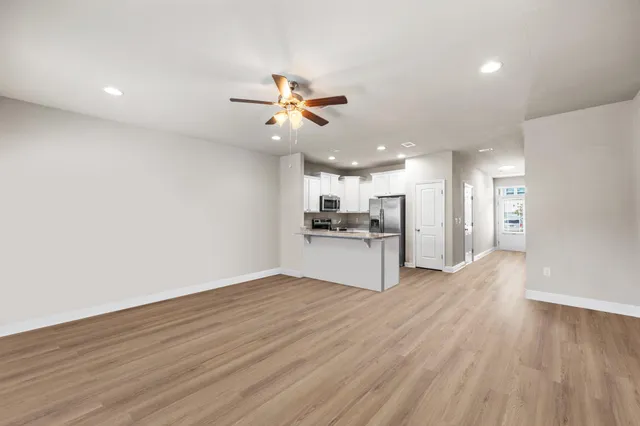 a view of a kitchen with a sink and a refrigerator
