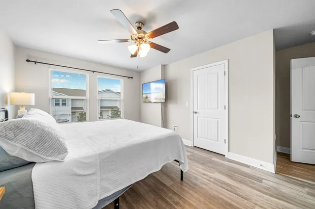 a bedroom with a large bed and a chandelier