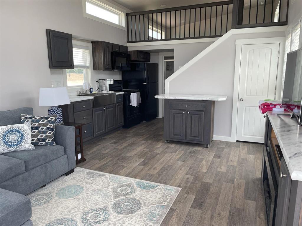 5226 Waterfront Road Kerens, TX 75144 - Photo 2 of 7 a living room with furniture and a flat screen tv
