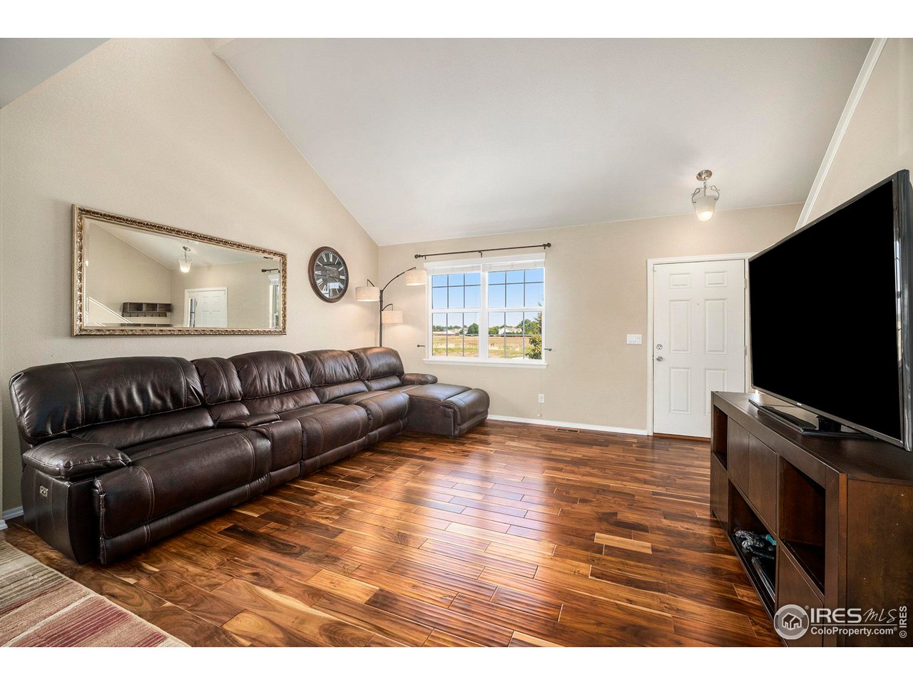 8421 Raspberry Drive Frederick, CO 80504 - Photo 6 of 24 a living room with furniture and a flat screen tv