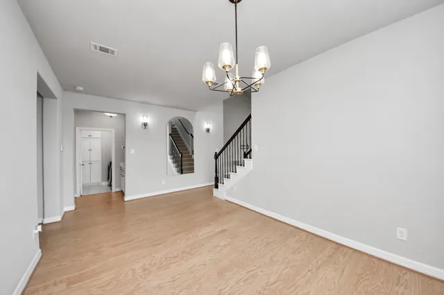 an empty room with windows and fireplace