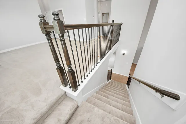 an empty room with windows and ceiling fan