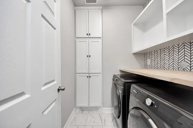 a spacious bathroom with a double vanity sink mirror and double