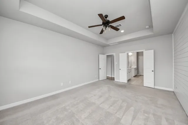 a bathroom with a bathtub a double vanity sink a vanity a window and a mirror