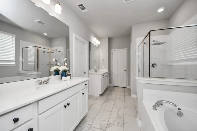 a bathroom with a double vanity sink and a mirror