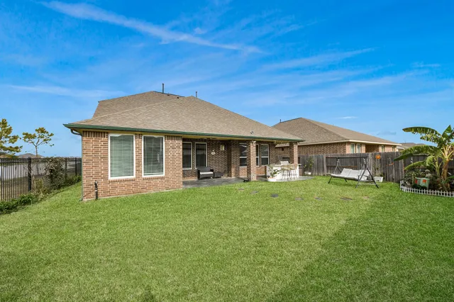 an aerial view of a house a yard and a swimming pool