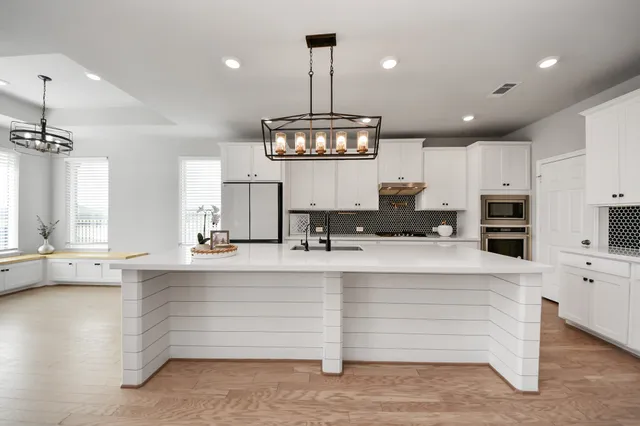 a view of empty room with fireplace and wooden floor