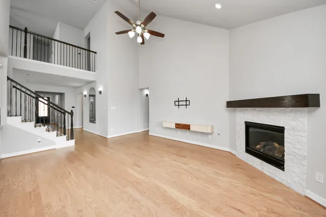 a view of a room with a ceiling fan and window