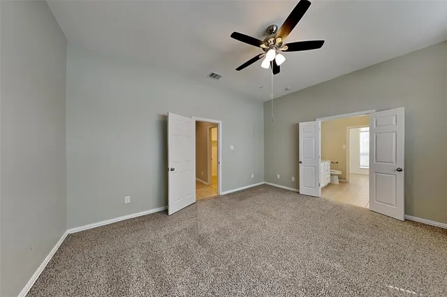 a large kitchen with stainless steel appliances a stove a sink and a microwave