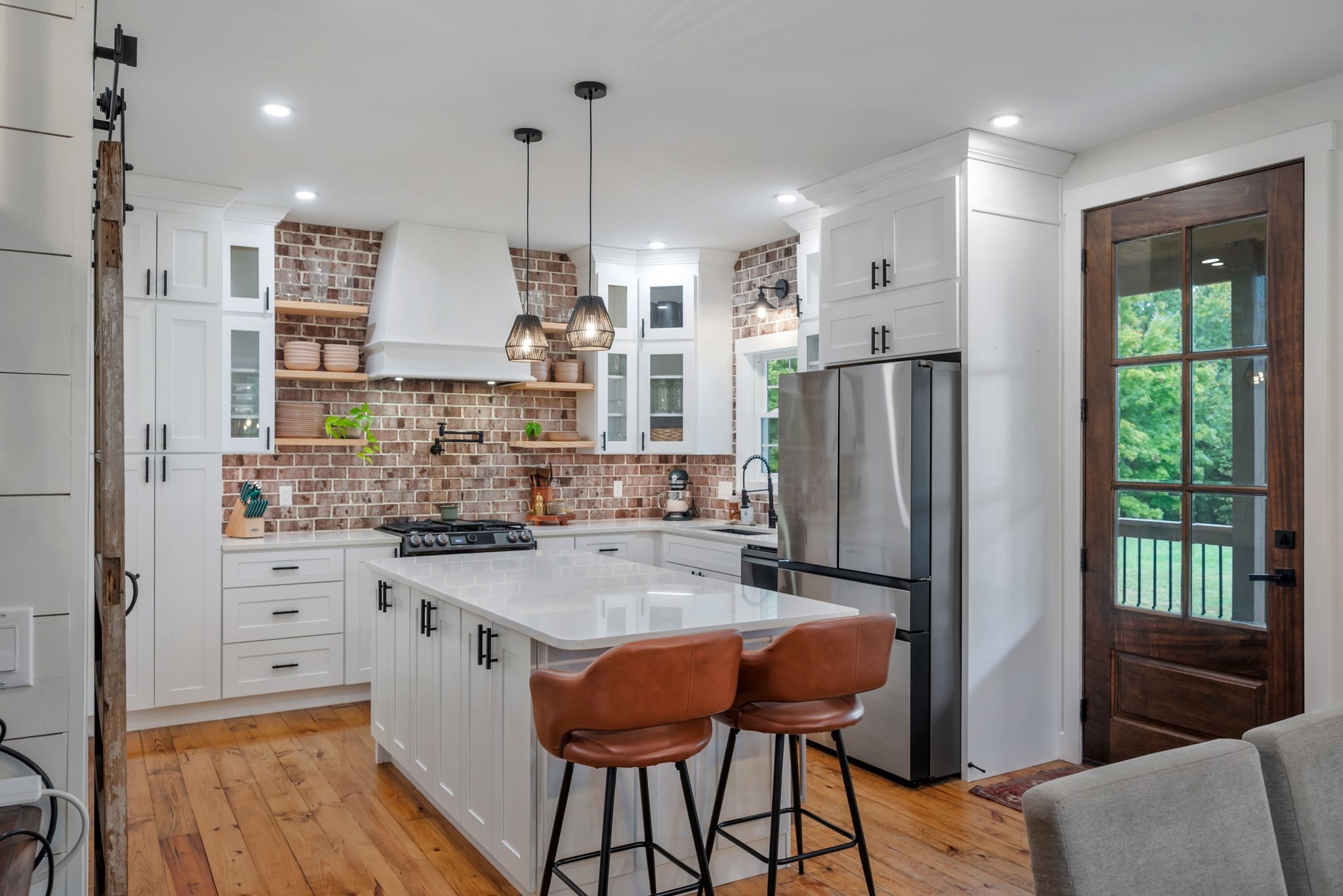 1006 Cherokee Trail Springfield, TN 37172 - Photo 8 of 49 a kitchen with stainless steel appliances granite countertop a refrigerator a sink dishwasher a stove and white cabinets with wooden floor