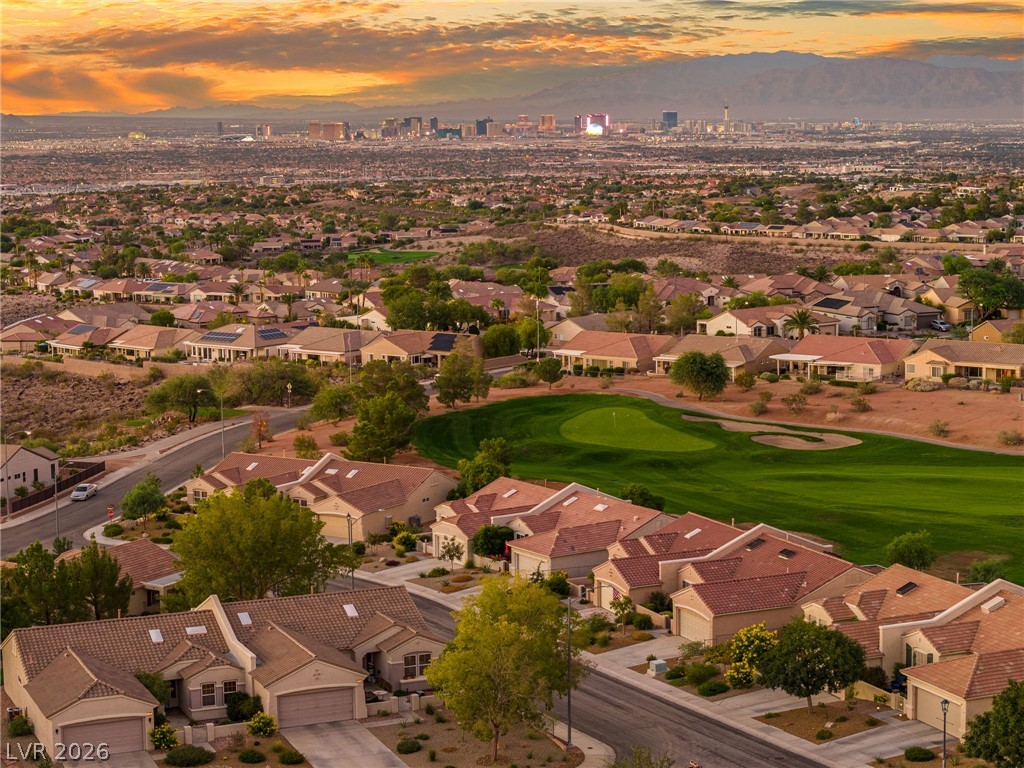 2738 Grand Forks Road Henderson, NV 89052 - Photo 47 of 52 Sweeping views across a golf course green toward the distant city skyline under sunset skies.