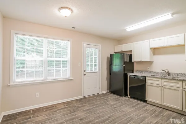 a kitchen with a refrigerator stove and sink