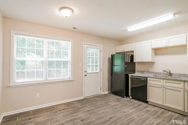 a kitchen with a refrigerator stove and sink