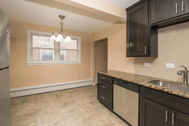 a kitchen that has a sink a stove and a window