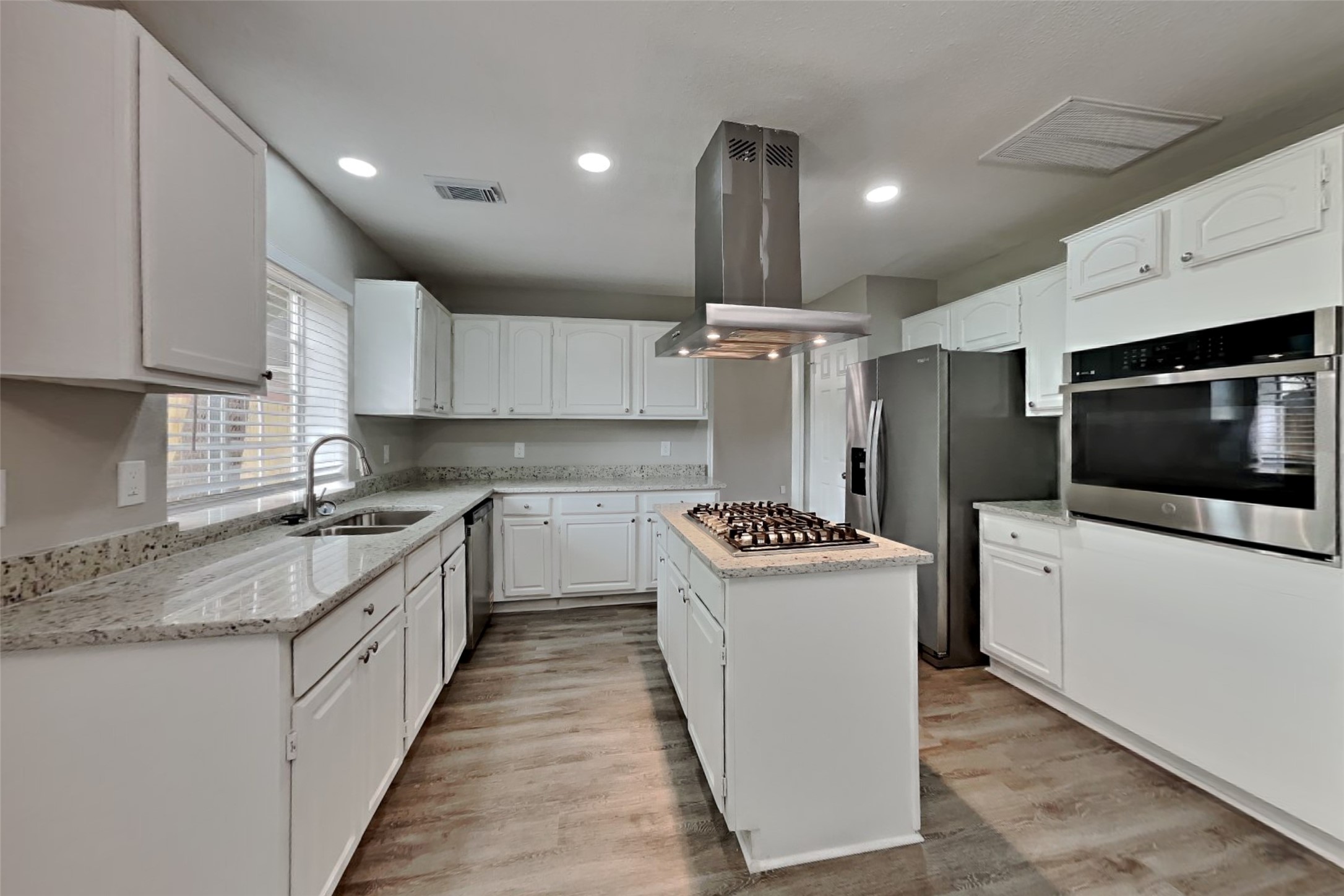 16303 Hickory Point Road Houston, TX 77095 - Photo 5 of 21 a kitchen with a sink a stove and cabinets