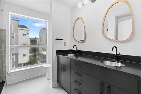 a bathroom with a double vanity sink and a mirror