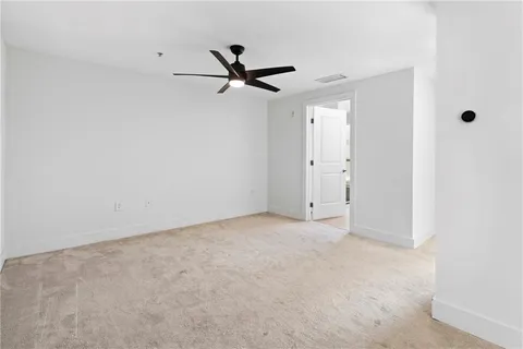 a view of a big room with a ceiling fan