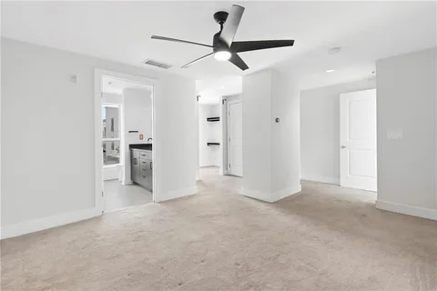 a view of a big room with closet and a ceiling fan