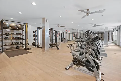 an aerial view of a city with lots of residential buildings ocean and mountain view in back