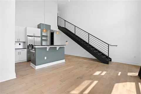 a view of entryway and hall with wooden floor