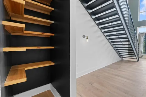 a view of walk in closet with clothes and shoes