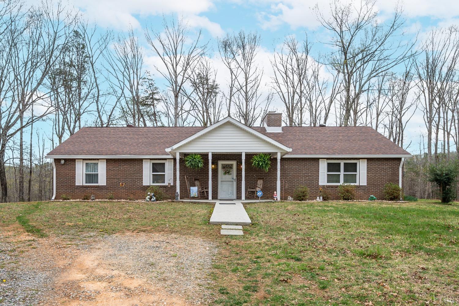 a front view of house with yard and trees around