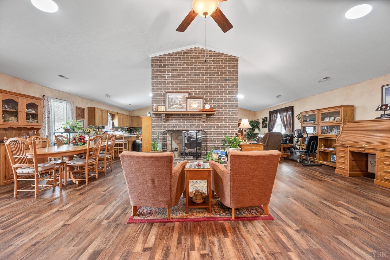 1425 Kentmoor Farm Road Madison Heights, VA 24572 - Photo 15 of 47 a living room with furniture a wooden floor and a fireplace