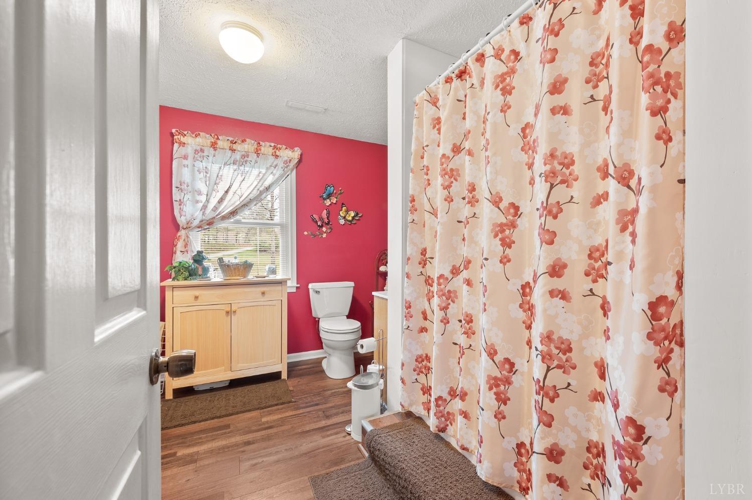 1425 Kentmoor Farm Road Madison Heights, VA 24572 - Photo 28 of 47 a bathroom with a toilet and a shower curtain