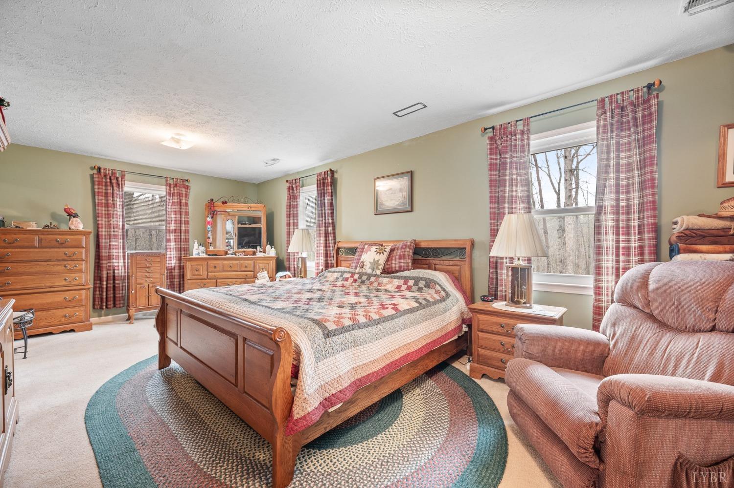 1425 Kentmoor Farm Road Madison Heights, VA 24572 - Photo 30 of 47 a bedroom with a large bed couch and a window